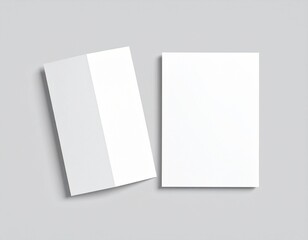 Blank folded paper mockup on gray background. Top view of empty white sheet template for flyer, brochure, invitation, or leaflet design. Minimal stationery concept with clean surface and soft shadows.