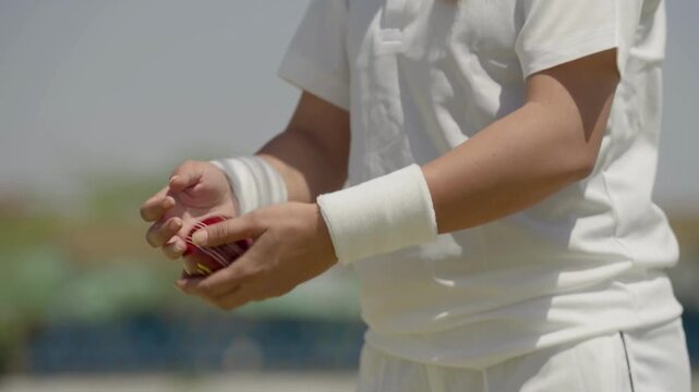 Close Up of Woman Bowler’s Hands Holding Cricket Ball in 4K Ultra HD | Female Cricketer Preparing to Bowl, Sports Training Detail, Hand Grip Technique and Athletic Focus - Powered by Adobe