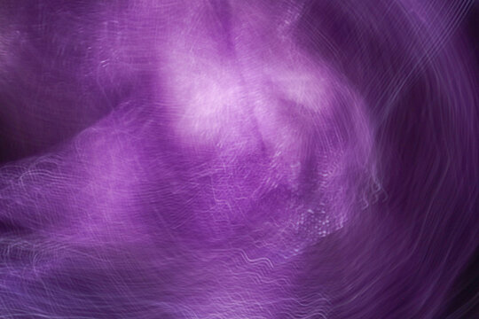 Violet abstract blurred background with glowing light wave texture