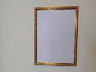 Unframed potential empty gold frame on wall art display indoor setting minimalist viewpoint