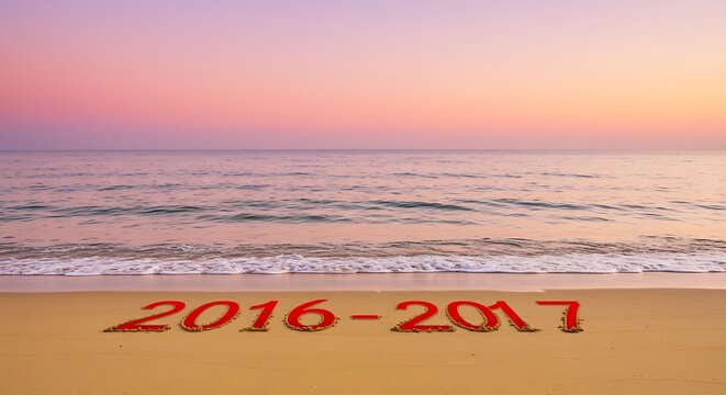 Years 2016 and 2017 Written on Sand at Sunset.