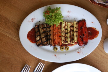 Grilled Vegetables Served on Plate with Garnishes and Red Sauce