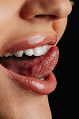 Fototapeta premium Close-Up of Woman’s Mouth with Tongue Out