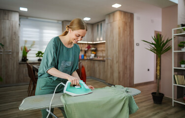 Enjoying the simplicity of ironing clothes in a cozy kitchen
