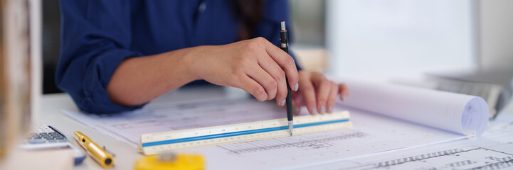 Architect professional designs modern building blueprints planning future urban projects using...