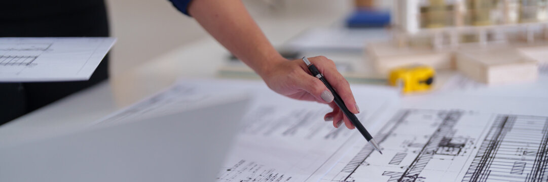 Professional architect designer review architectural blueprint building plan project development engineering drawing office workspace creative solution