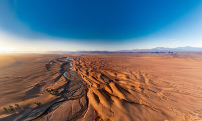 Vast, desolate, arid, desert landscape with a dried up river bed. Global warming, drought, and water shortage concept.