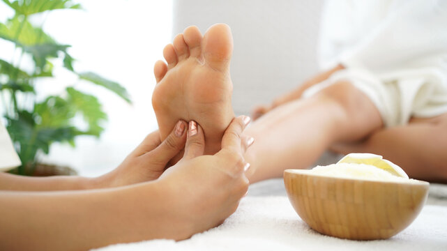 Close up foots spa.  Spa body treatment for beauty and aroma therapy product for female feet and hand spa relax and healthy care,  Masseur doing massage with treatment sugar scrub.  Thailand