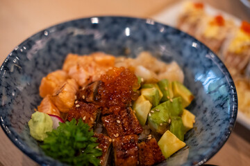 Donburi, a Japanese rice bowl dish of seafood. Including raw fish such as Salmon, Ikura, Unagi, and Avocado