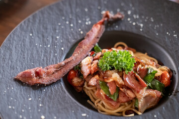 Spaghetti spicy bacon served on plate