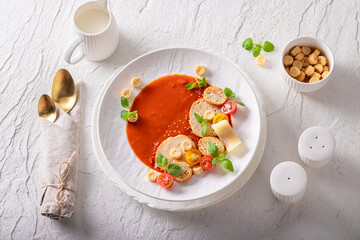 Refined tomato soup as culinary artistry in top chef kitchen.