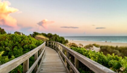 Wooden walkway leading to beach at sunset