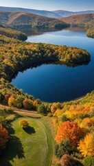 Naklejka premium Serene lake with autumn foliage and a golf course fall