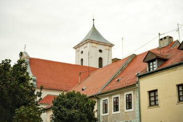 Church tower and rooftops in Osijek Croatia on cloudy day