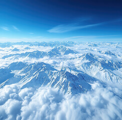Obraz premium Aerial drone shot of majestic snow-covered mountain peaks rising above a sea of clouds under clear blue sky, vast and epic landscape