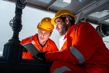 Industrial engineer teamwork maintenance pipeline valves air HVAC cooling systems at construction site. Male technician in safety uniform inspect building exterior pipeline valves or plumbing systems.