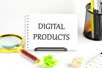 The concept of the info business. The text of DIGITAL PRODUCTS is written in a notebook on a white background