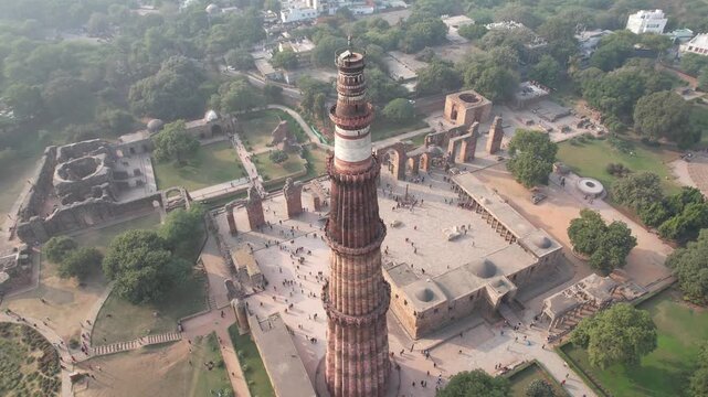Aerial Drone footage of Qutub Minar a Unesco world heritage site in New Delhi capital city of India monuments of Delhi during the day .