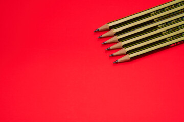 Fototapeta premium Pencils on a red background