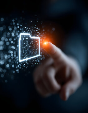 The future of data management is represented by a figer touching a glowing foler icon, showcasing the poer of technology.