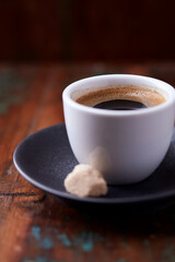 Cup of coffee on rustic wooden background. Soft focus. Copy space	