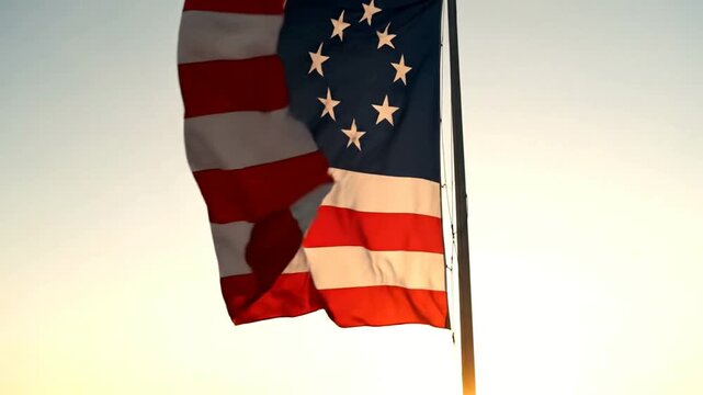 The Betsy Ross American flag with thirteen stars in a circle waving against a bright sky.