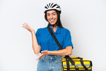 Young caucasian woman with thermal backpack isolated on white background extending hands to the side for inviting to come