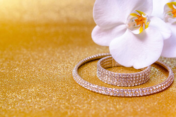Bracelet and necklace on a gold shiny background
