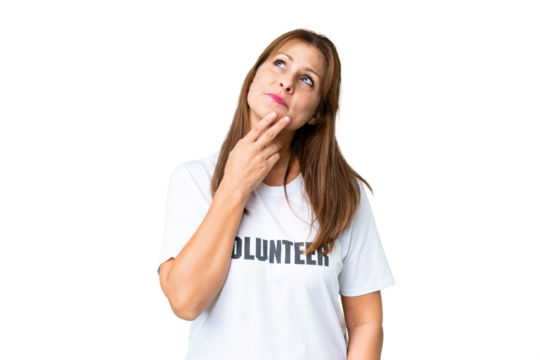 Middle age volunteer woman over isolated background looking up while smiling