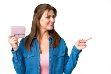 Middle age caucasian woman holding wallet over isolated background pointing to the side to present a product