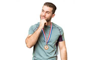 Young handsome blonde man with medals over isolated chroma key background looking to the side