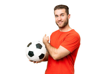 Handsome young football player man over isolated chroma key background pointing back © luismolinero
