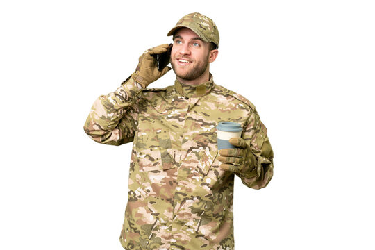 Military man over isolated chroma key background holding coffee to take away and a mobile