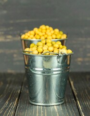 Yellow peas in metal buckets