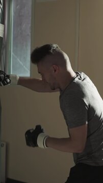 Team of robust athletes involved in kick-boxing strikes punching bags. Enhancing physical fitness and developing muscle strength. Challenging and releasing negative emotions through powerful blows