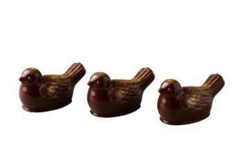Three exquisite dark chocolate petit fours, sculpted as elegant birds with shimmering gold dust, arranged on a seamless transparent background with high-key macro lighting, concept of luxury gourmet