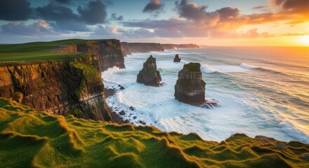Dramatic sunset over the cliffs of moher, ireland, with waves crashing against the sea stacks and lush green grass on the clifftops