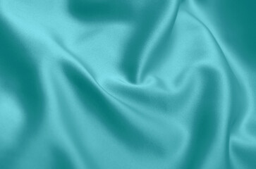 Smooth elegant green silk or satin luxury cloth texture can use as abstract background with copy space.