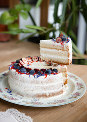 Vanilla cake with white cream and berries