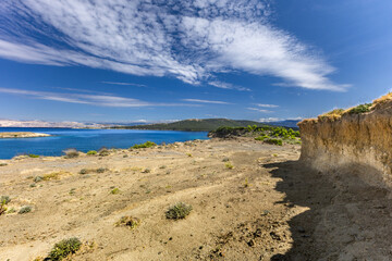 Azure water in the Adriatic Sea, rocky coast of the island of Rab, cloudy, threatening sky, Strucic beach