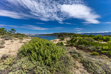 Azure water in the Adriatic Sea, rocky coast of the island of Rab, cloudy, threatening sky, Strucic...