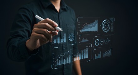 Businessman Analyzing Data Visualizations on Transparent Digital Interface in Dark Environment