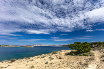Azure water in the Adriatic Sea, rocky coast of the island of Rab, cloudy, threatening sky, Strucic...