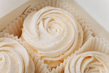 Delicate vanilla marshmallows in elegant packaging, soft swirl texture, close-up