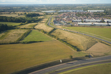 East Midlands Airport, England - September 5 2025: Aerial view of countryside and industrial buildings near runway