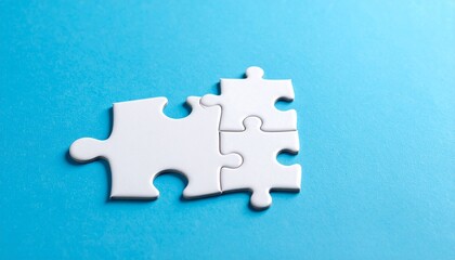 Obraz premium Four white puzzle pieces on blue background