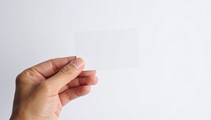 A person's hand holding a blank rectangular card, an empty space for a message or branding on a clean white studio background