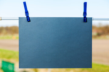 Empty blue cardboard on a clothline