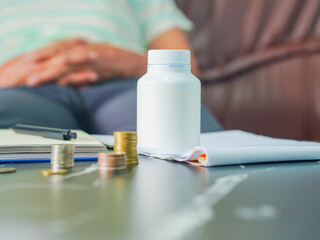 Retirement financial plan and health plan for old age. Medicine bottles, notebooks, money, and medical equipment are placed on the table. Lifestyle wellness health care. Healthy concept