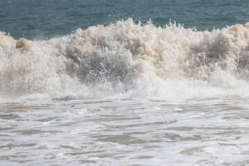 The ocean is rough and the waves are high